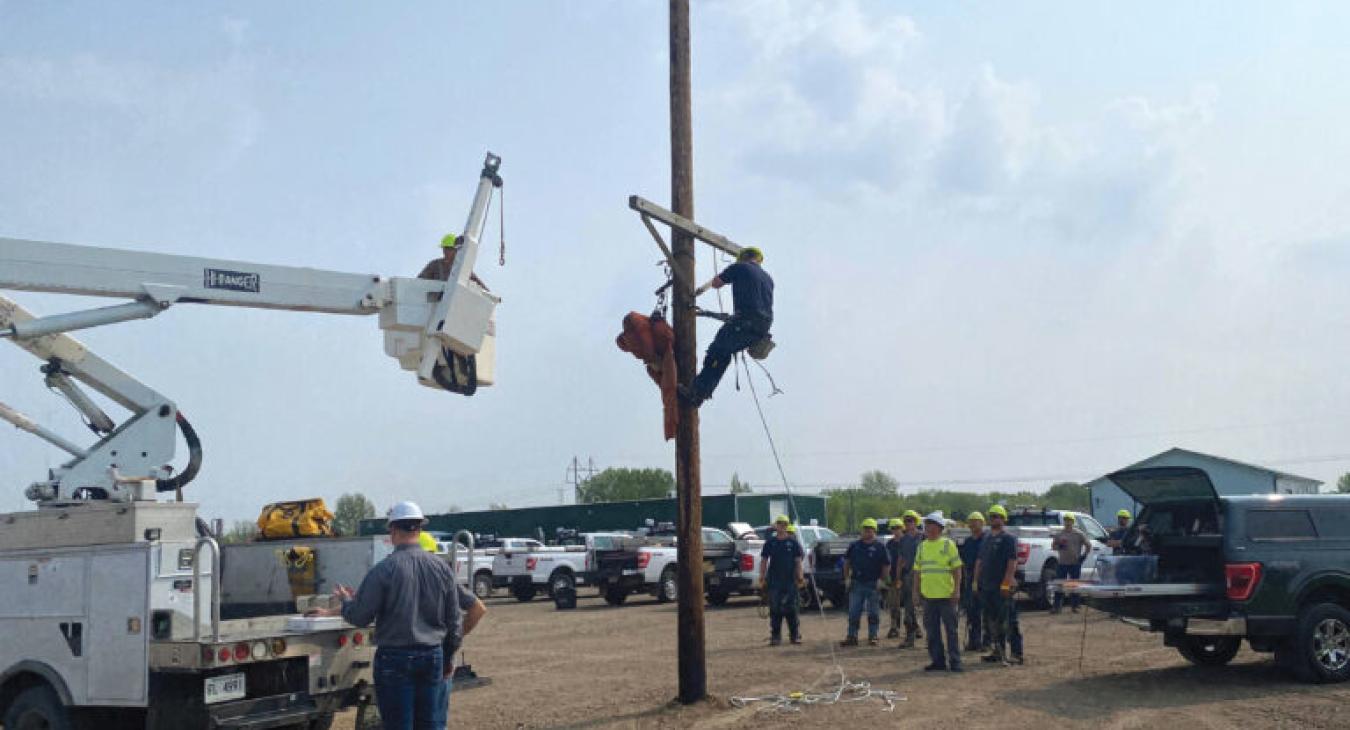   Warehouse worker Joleen Landis participates in a bucket rescue.  MREA safety instructors provided lineworkers with one of the most important training exercises in the electric utility industry – pole top rescue.